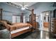 The main bedroom has a four-poster bed, stylish furnishings, and an ensuite bathroom at 15104 County Road 48, Astatula, FL 34705