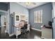 Office space featuring a white desk with a wooden countertop, a chair and hardwood floors at 15104 County Road 48, Astatula, FL 34705