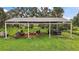 Outdoor storage building with a metal roof offers covered space for equipment, trailer, and vehicle parking at 15104 County Road 48, Astatula, FL 34705