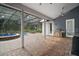 View of the outdoor pool, grill and covered patio with brick flooring at 15104 County Road 48, Astatula, FL 34705