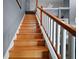 Wooden staircase with white railings leading to the upper level of the house at 15104 County Road 48, Astatula, FL 34705