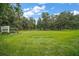 A view of the expansive yard on this property with beautiful mature trees and lush green grass at 15104 County Road 48, Astatula, FL 34705