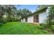 Backyard showing exterior of home with sliding glass doors, wooden deck and patio at 15925 Summit Ct, Clermont, FL 34711