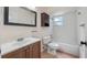 Bathroom with tiled floors, toilet, tub, shower, and wooden vanity at 15925 Summit Ct, Clermont, FL 34711