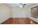 A spacious room with wood flooring, a ceiling fan, and a window with blinds at 15925 Summit Ct, Clermont, FL 34711