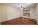 Bedroom with wooden floors, a window, and a ceiling fan at 15925 Summit Ct, Clermont, FL 34711