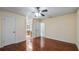 Large bedroom with wood floors, ceiling fan, and access to bathroom at 15925 Summit Ct, Clermont, FL 34711