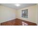 Bedroom featuring hardwood floors, a large window, and ample natural light at 15925 Summit Ct, Clermont, FL 34711