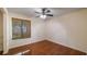 Bedroom with wooden floor, ceiling fan and window with bamboo shade at 15925 Summit Ct, Clermont, FL 34711