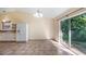 Cozy dining area featuring tile floors and views of the lush outdoor scenery through sliding doors at 15925 Summit Ct, Clermont, FL 34711