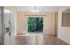 Bright dining area with a view of lush greenery through the sliding glass doors at 15925 Summit Ct, Clermont, FL 34711