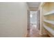 Hallway with tiled floors and recessed shelves leading to the bathroom at 15925 Summit Ct, Clermont, FL 34711