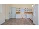 Well-lit kitchen with white cabinets and tile flooring, ready for your personal touch at 15925 Summit Ct, Clermont, FL 34711