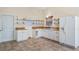 Bright kitchen with white cabinets, butcher block counters and tile flooring at 15925 Summit Ct, Clermont, FL 34711