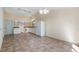 Open-concept kitchen and dining area with white cabinets, tile floors and modern lighting at 15925 Summit Ct, Clermont, FL 34711