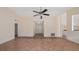 Open living room with tiled floors, ceiling fan, and a view of the entrance at 15925 Summit Ct, Clermont, FL 34711