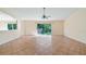Open living space features tile flooring and sliding glass doors to outside patio at 15925 Summit Ct, Clermont, FL 34711