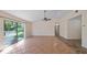 Bright living room featuring tile flooring and sliding glass doors that open to the outdoors at 15925 Summit Ct, Clermont, FL 34711