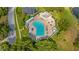Overhead shot of a community pool with ample lounge chairs and shaded areas for relaxation at 15925 Summit Ct, Clermont, FL 34711