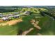 Golf community view with lush greens, strategically placed sand traps, and a row of upscale homes at 16030 Vetta Dr, Bella Collina, FL 34756