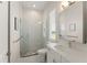 Modern bathroom with tiled shower, glass door, and vanity with ample counter space at 16030 Vetta Dr, Bella Collina, FL 34756
