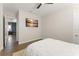 Cozy bedroom with a queen bed, hardwood floors, and modern amenities at 16030 Vetta Dr, Bella Collina, FL 34756