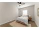 Minimalist bedroom featuring a queen bed, a modern ceiling fan, and natural lighting at 16030 Vetta Dr, Bella Collina, FL 34756