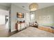 Stylized bedroom featuring wood crib, dresser, and decorative light fixture for a warm and inviting atmosphere at 16030 Vetta Dr, Bella Collina, FL 34756