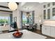 Dining area and kitchen view shows hardwood floors, and views of the outdoor scenery at 16030 Vetta Dr, Bella Collina, FL 34756