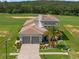 Stunning home exterior with tile roof, paver driveway, landscaping, and a golf course view at 16030 Vetta Dr, Bella Collina, FL 34756