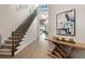 Elegant foyer features a staircase, wooden floors, and stylish decor at 16030 Vetta Dr, Bella Collina, FL 34756