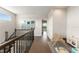 Bright upstairs hallway with wood floors leading to a play area and staircase at 16030 Vetta Dr, Bella Collina, FL 34756