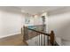 Upstairs landing featuring wood floors, iron railings, and a cozy area at 16030 Vetta Dr, Bella Collina, FL 34756