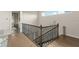 Hallway landing featuring a wrought iron railing, wood floors and views to multiple upstairs rooms at 16030 Vetta Dr, Bella Collina, FL 34756
