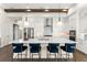 Bright kitchen features an island with seating, stainless appliances, and stylish pendant lighting at 16030 Vetta Dr, Bella Collina, FL 34756
