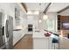 Modern kitchen with stainless steel appliances, white cabinetry, and stylish pendant lighting at 16030 Vetta Dr, Bella Collina, FL 34756