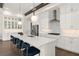 Bright kitchen features an island with seating, stainless appliances, white cabinets, and stylish pendant lighting at 16030 Vetta Dr, Bella Collina, FL 34756