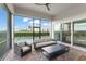 Screened lanai with comfortable seating and a view of the pool and backyard at 16030 Vetta Dr, Bella Collina, FL 34756
