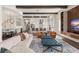Spacious living room with an open concept design, modern furnishings, hardwood floors, and a kitchen view at 16030 Vetta Dr, Bella Collina, FL 34756