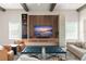 Bright and airy living room with modern decor, wood beams, stylish furnishings, and a large screen TV at 16030 Vetta Dr, Bella Collina, FL 34756