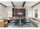 Open concept living room with ceiling beams, a large TV, and stylish decor at 16030 Vetta Dr, Bella Collina, FL 34756