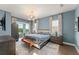 Serene main bedroom with blue walls, a king bed, and access to the outdoor space at 16030 Vetta Dr, Bella Collina, FL 34756