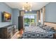 Main bedroom featuring modern furniture, an outdoor view, and sophisticated color scheme at 16030 Vetta Dr, Bella Collina, FL 34756