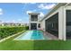 A private pool surrounded by lush greenery, complemented by the home's architecture and screened lanai at 16030 Vetta Dr, Bella Collina, FL 34756