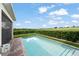 Backyard pool area featuring lush landscaping, enhancing privacy and outdoor enjoyment at 16030 Vetta Dr, Bella Collina, FL 34756