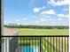 Enjoy expansive golf course views from the balcony, overlooking the pool and lush greenery at 16030 Vetta Dr, Bella Collina, FL 34756