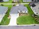 Birds-eye view of home with green lawn and manicured landscaping at 16863 Se 110Th Court Rd, Summerfield, FL 34491