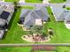 Aerial view showcases a home with lush landscaping, a screened lanai, and a well-manicured lawn at 16863 Se 110Th Court Rd, Summerfield, FL 34491