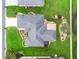 Overhead view of a home with a well-maintained roof, beautiful landscaping, and a private backyard at 16863 Se 110Th Court Rd, Summerfield, FL 34491