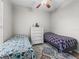 Bright bedroom featuring two beds, a ceiling fan, and a neutral color scheme at 16863 Se 110Th Court Rd, Summerfield, FL 34491